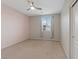 Bedroom with neutral carpet and paint, ceiling fan, window, and closet at 640 Finch Island Ave, Henderson, NV 89015