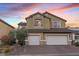 Charming two-story home featuring a two-car garage, desert landscaping and vibrant sunset backdrop at 640 Finch Island Ave, Henderson, NV 89015