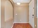 Foyer with arched doorway, white front door, neutral color palette and wood floors at 640 Finch Island Ave, Henderson, NV 89015