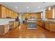 Spacious kitchen showcasing wood cabinets, stainless steel appliances and a functional island at 640 Finch Island Ave, Henderson, NV 89015