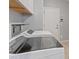 Modern laundry room featuring a front-load washer, a dryer, and upper cabinet storage at 640 Finch Island Ave, Henderson, NV 89015