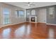 Spacious living room featuring a cozy fireplace, modern ceiling fan, and beautiful hardwood floors at 640 Finch Island Ave, Henderson, NV 89015
