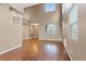 Bright living room featuring lots of windows, high ceilings, a staircase, and wood floors at 640 Finch Island Ave, Henderson, NV 89015