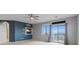 Living Room with blue accent wall, fireplace, ceiling fan, and sliding glass doors leading to balcony at 640 Finch Island Ave, Henderson, NV 89015