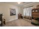 Simple bedroom with neutral walls, carpeted floors, and a large window at 6630 Cave Rock Ave, Las Vegas, NV 89110