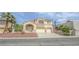 Inviting two-story home with a three car garage and well-maintained landscaping at 6630 Cave Rock Ave, Las Vegas, NV 89110