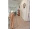Hallway with light wood railing, neutral carpet, a wooden dresser, and white walls at 6630 Cave Rock Ave, Las Vegas, NV 89110