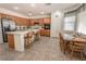 Traditional kitchen featuring wood cabinetry, a tile backsplash, and a central island with bar seating at 6630 Cave Rock Ave, Las Vegas, NV 89110