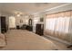 Airy main bedroom featuring carpet flooring, multiple windows, and ample natural light at 6630 Cave Rock Ave, Las Vegas, NV 89110