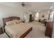 Spacious main bedroom featuring a large bed, carpet flooring, a ceiling fan, and ample natural light at 6630 Cave Rock Ave, Las Vegas, NV 89110