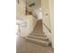 Carpeted staircase leads to the upper level with wooden railing and tile flooring on the lower level at 6630 Cave Rock Ave, Las Vegas, NV 89110