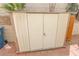 Tan and white storage shed with double doors on brick paver pad at 6630 Cave Rock Ave, Las Vegas, NV 89110