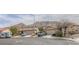 Street view of a neighborhood with well-maintained homes and mountain backdrop at 6630 Cave Rock Ave, Las Vegas, NV 89110