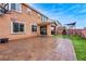 Wide backyard with a basketball hoop, play structure, and a stone-paved patio at 817 Great Sky Ct, North Las Vegas, NV 89084