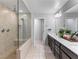 Bathroom featuring a glass shower enclosure with a bench and dual sinks with modern fixtures at 817 Great Sky Ct, North Las Vegas, NV 89084