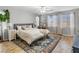 Bright bedroom with two windows, a ceiling fan, a bed, and sewing station at 817 Great Sky Ct, North Las Vegas, NV 89084