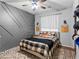 Cozy bedroom featuring a decorative wall, ceiling fan, and a bed with Chiefs themed decor at 817 Great Sky Ct, North Las Vegas, NV 89084