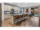 Modern kitchen with a large island, granite countertops, stainless steel appliances and bar stool seating at 817 Great Sky Ct, North Las Vegas, NV 89084
