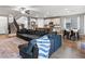 Open concept living space with a large sectional, kitchen with island, and dining area with stylish decor at 817 Great Sky Ct, North Las Vegas, NV 89084