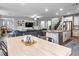 Open concept living space with a modern kitchen, dining area, comfortable seating, and stylish decor at 817 Great Sky Ct, North Las Vegas, NV 89084