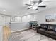 Upstairs loft area featuring a leather couch, ceiling fan, and plenty of natural light at 817 Great Sky Ct, North Las Vegas, NV 89084