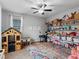 Spacious playroom with shelves filled with toys, a wooden playhouse, and a colorful rug at 817 Great Sky Ct, North Las Vegas, NV 89084