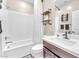 Bathroom featuring a shower over tub, modern vanity, and industrial shelves at 8507 Insignia Ave # 102, Las Vegas, NV 89178