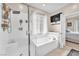 Bathroom featuring shower, soaking tub, window, and access to bedroom at 8507 Insignia Ave # 102, Las Vegas, NV 89178