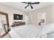 Well-lit bedroom features ceiling fan, dresser, and ensuite bathroom at 8507 Insignia Ave # 102, Las Vegas, NV 89178