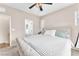 Spacious bedroom with tufted headboard, ceiling fan, and natural light at 8507 Insignia Ave # 102, Las Vegas, NV 89178