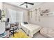 Cozy bedroom with a ceiling fan, natural light, and stylish decor on the walls at 8507 Insignia Ave # 102, Las Vegas, NV 89178