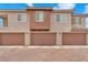 Spacious townhouse exteriors featuring attached garages and a brick paved parking area at 8507 Insignia Ave # 102, Las Vegas, NV 89178