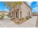 Charming townhome with arched entryway, desert landscaping, and a well-maintained walkway to the front door at 8507 Insignia Ave # 102, Las Vegas, NV 89178