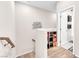 Bright hallway with wood floors and storage shelves; bathroom access at 8507 Insignia Ave # 102, Las Vegas, NV 89178