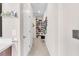 Hallway with storage: shelves, closet, and view of mirror at 8507 Insignia Ave # 102, Las Vegas, NV 89178