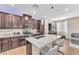 Spacious kitchen with dark wood cabinets, stainless steel appliances, and granite countertops at 8507 Insignia Ave # 102, Las Vegas, NV 89178