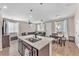 Bright and airy open floorplan with kitchen island, dining area, and comfortable living space at 8507 Insignia Ave # 102, Las Vegas, NV 89178