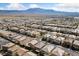Scenic aerial view showcasing a sprawling suburban development against a stunning mountain range at 8675 Principato St, Las Vegas, NV 89166