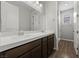 Bright bathroom featuring a double sink vanity with sleek countertops and modern fixtures at 8675 Principato St, Las Vegas, NV 89166