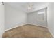 This bedroom features neutral walls, plush carpet and a ceiling fan with light at 8675 Principato St, Las Vegas, NV 89166