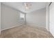 This bedroom features neutral walls, plush carpet and a ceiling fan with light at 8675 Principato St, Las Vegas, NV 89166