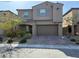 Charming two-story home with a two car garage, landscaped front yard, and stylish architectural details at 8675 Principato St, Las Vegas, NV 89166