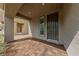 Inviting covered front porch with brick pavers and a view of the front door at 8675 Principato St, Las Vegas, NV 89166