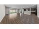 Open-concept living room flows into kitchen with stainless steel appliances and hardwood flooring at 8675 Principato St, Las Vegas, NV 89166
