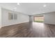 Spacious and bright living room with hardwood floors and sliding glass doors to the backyard at 8675 Principato St, Las Vegas, NV 89166