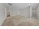 Spacious loft area featuring neutral walls, plush carpet flooring, and access to multiple rooms at 8675 Principato St, Las Vegas, NV 89166