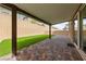 Inviting covered patio with brick pavers and a small patch of artificial grass, ideal for outdoor relaxation at 8675 Principato St, Las Vegas, NV 89166