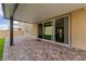 Charming covered patio extends from the house with paved flooring leading inside through glass sliding doors at 8675 Principato St, Las Vegas, NV 89166