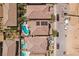 An outdoor pool in a residential backyard with desert landscaping with new construction behind at 9625 W Meranto Ave, Las Vegas, NV 89178