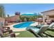 Backyard showcasing a pool, lounge chairs, grassy area, and covered patio perfect for relaxation at 9625 W Meranto Ave, Las Vegas, NV 89178